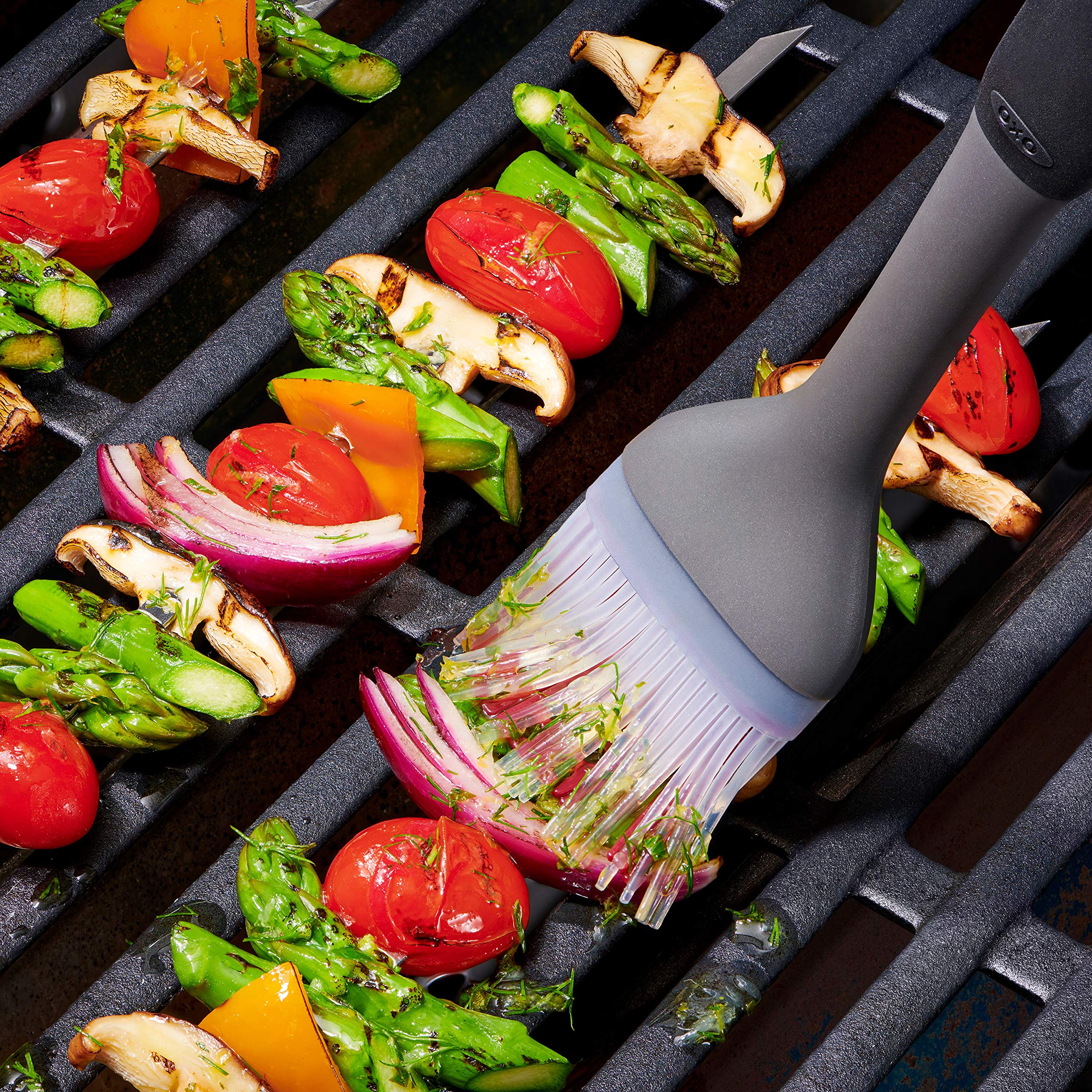 OXO close-up of patented center-hole silicone bristles holding sauce for precise application