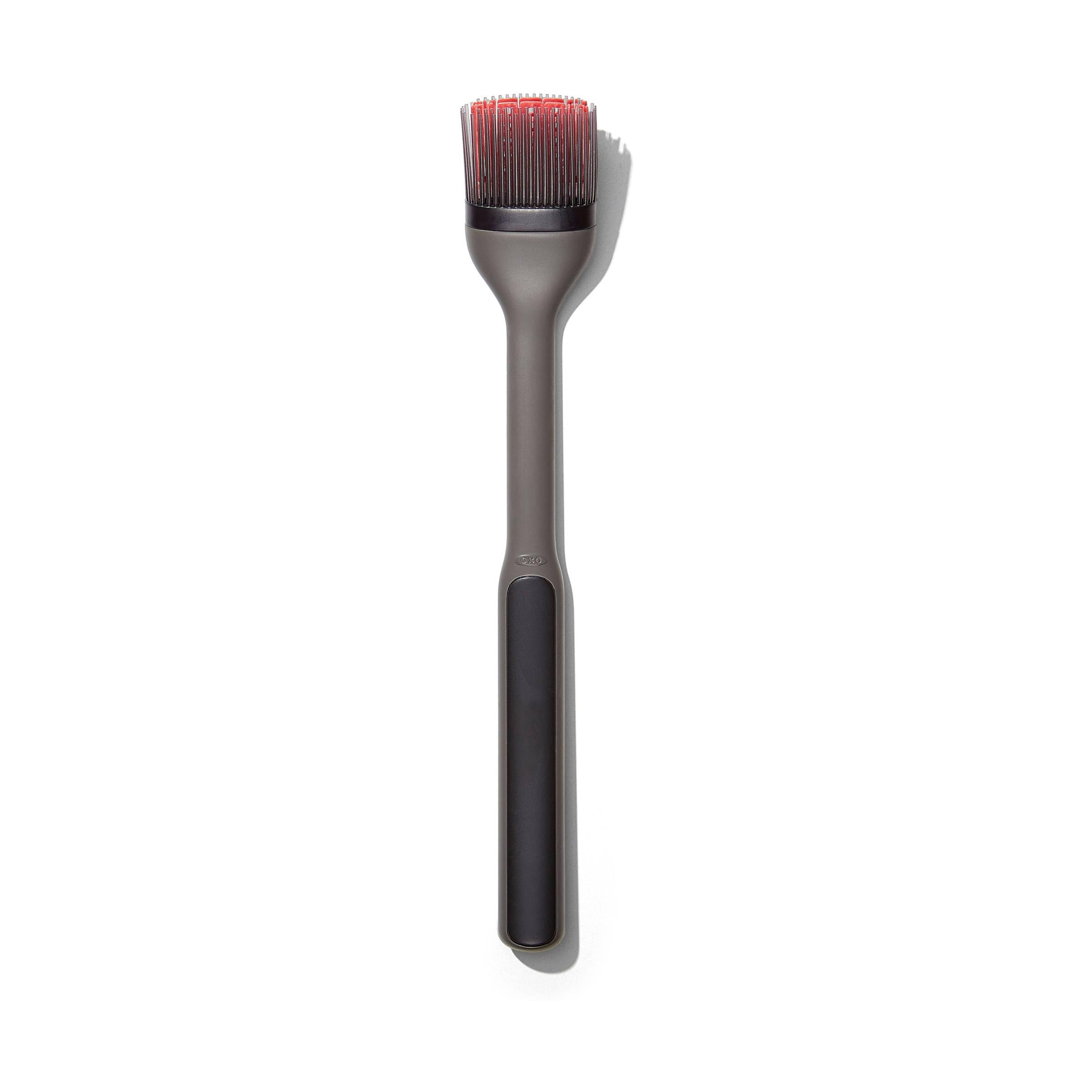 OXO front view of brush with angled head showing elevated bristles for cleaner countertops