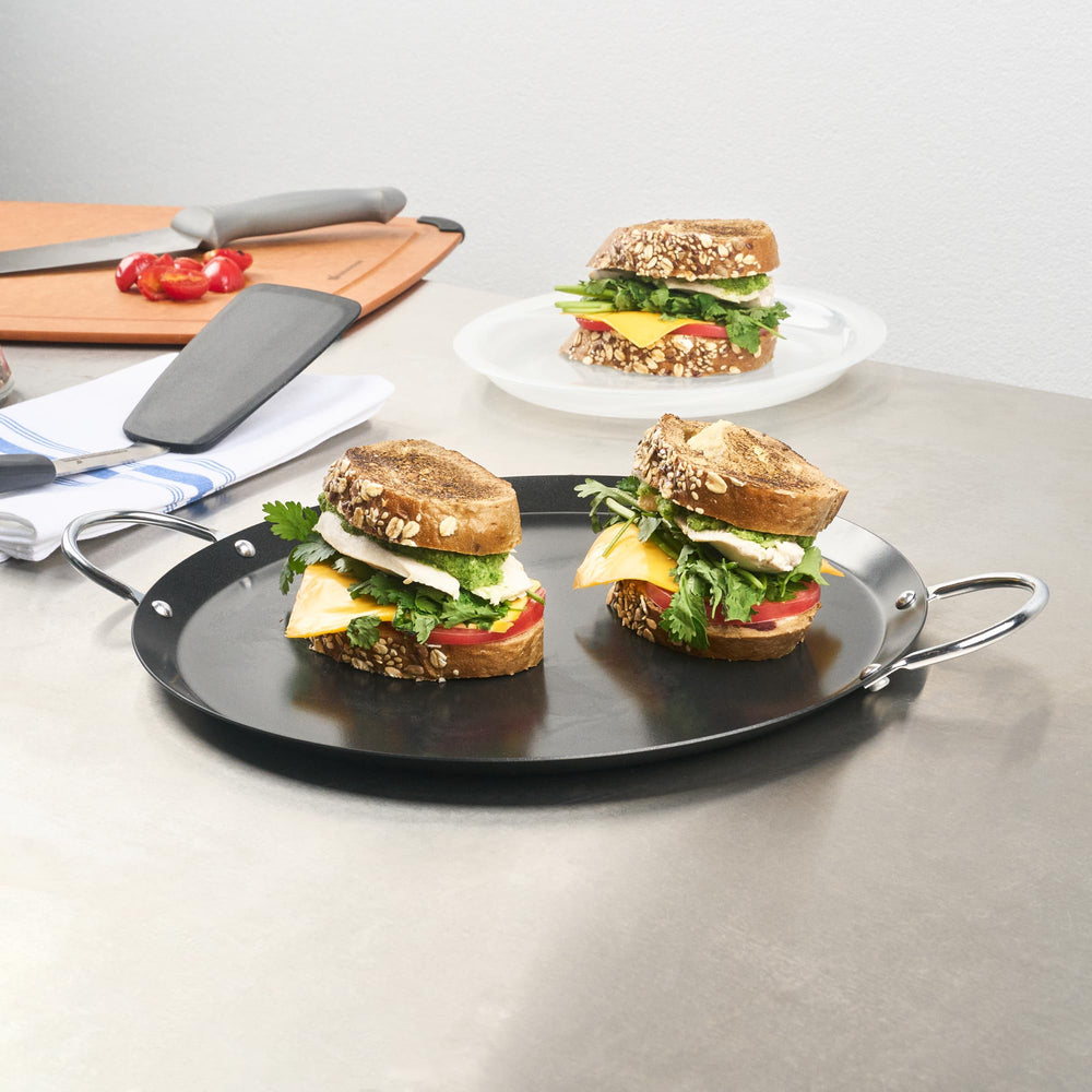 Restaurantware comal beside spatula showing size and practical scale for single-batch cooking