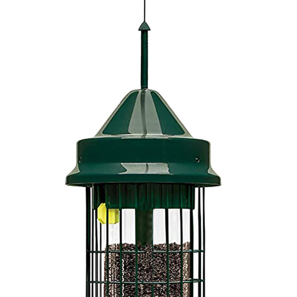 Squirrel Buster Classic next to scale illustrating 2.4-pound seed capacity
