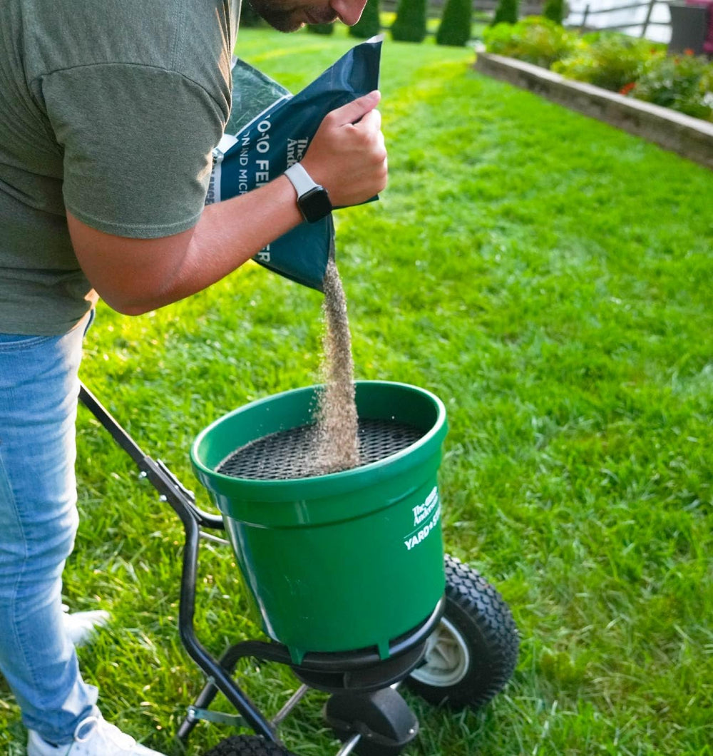Granules applied to a flower bed using The Andersons for healthier plants