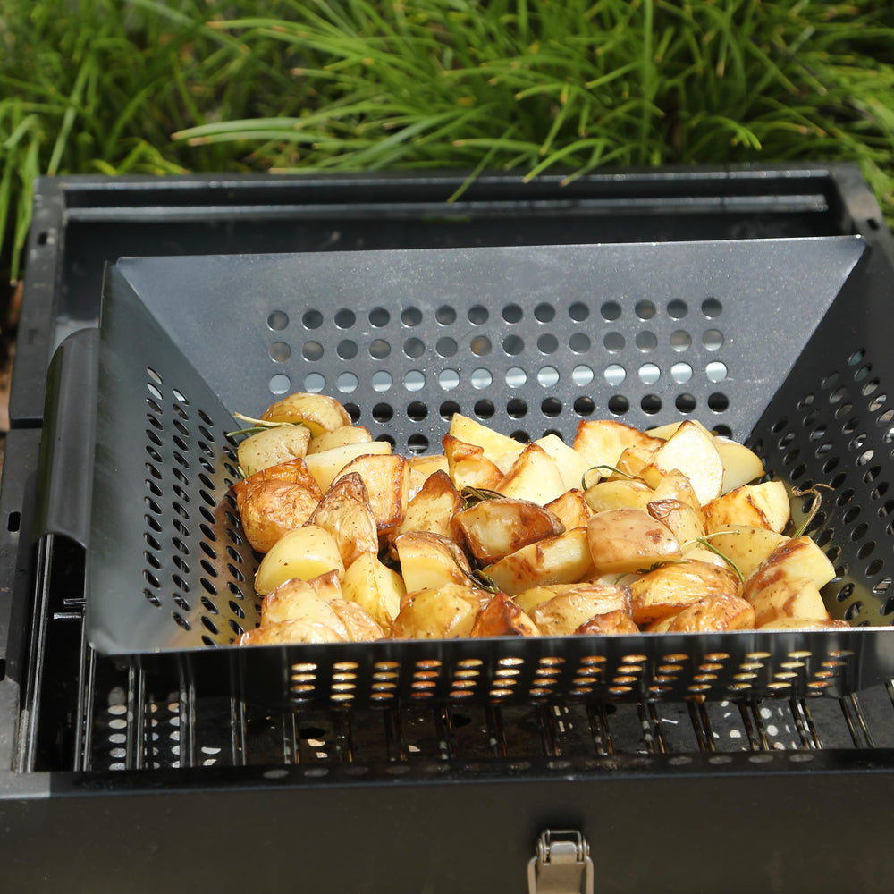 UNCO grill basket in backyard barbecue setting showing versatile use for gatherings