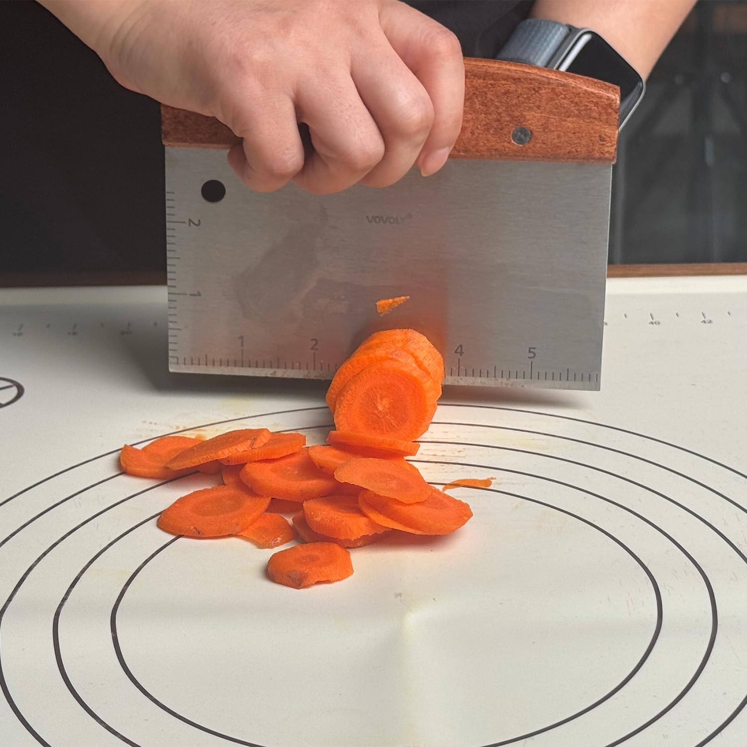 Vovoly used at backyard barbecue flipping ingredients on cast-iron griddle for grilling