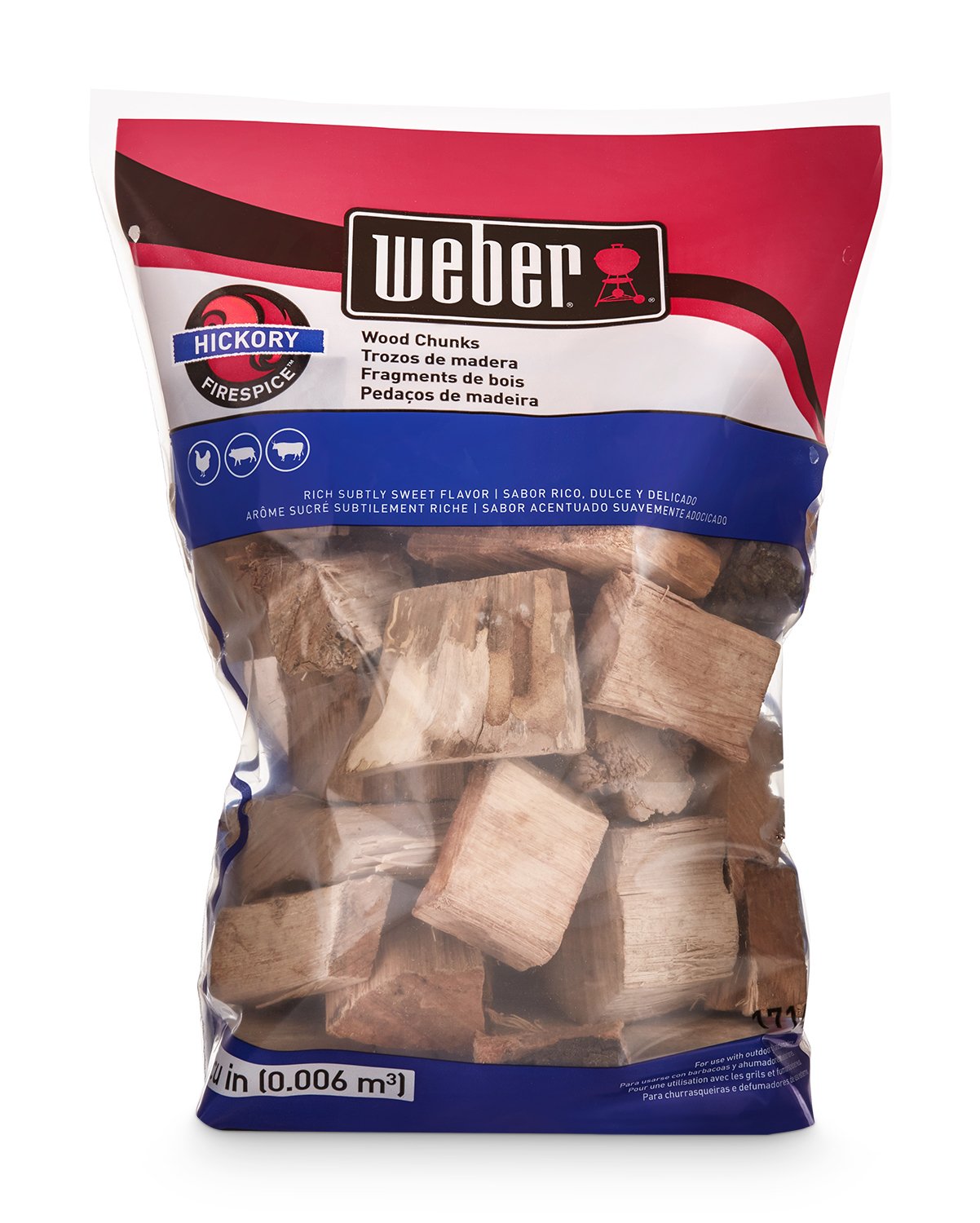 Weber hickory chunks on hot coals inside grill producing steady smoke for flavor
