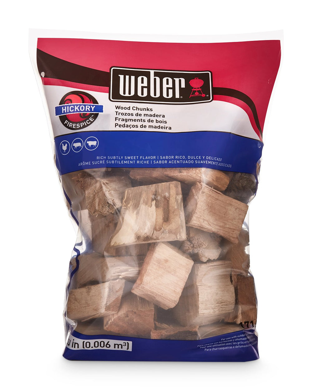 Weber hickory chunks on hot coals inside grill producing steady smoke for flavor