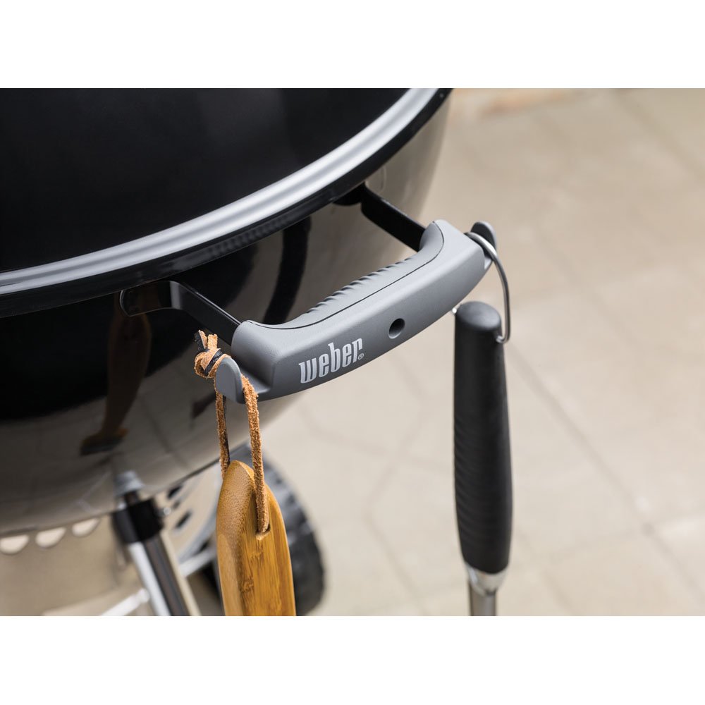Weber hinged cooking grate close-up enabling quick charcoal top-ups while grilling