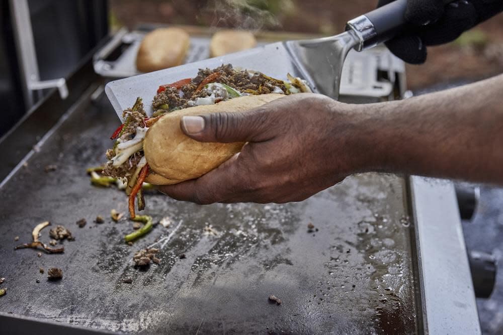 Weber warming rack handle and hang loop close-up showing secure grip and convenient storage benefit