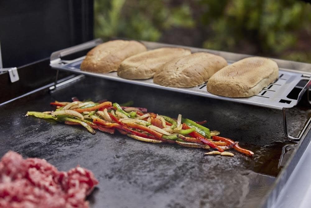 Weber warming rack holding toasted buns on griddle showing even warming benefit
