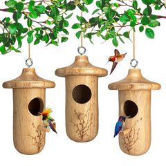 yewacne front view of three wooden hummingbird houses showing rustic appeal and natural shelter
