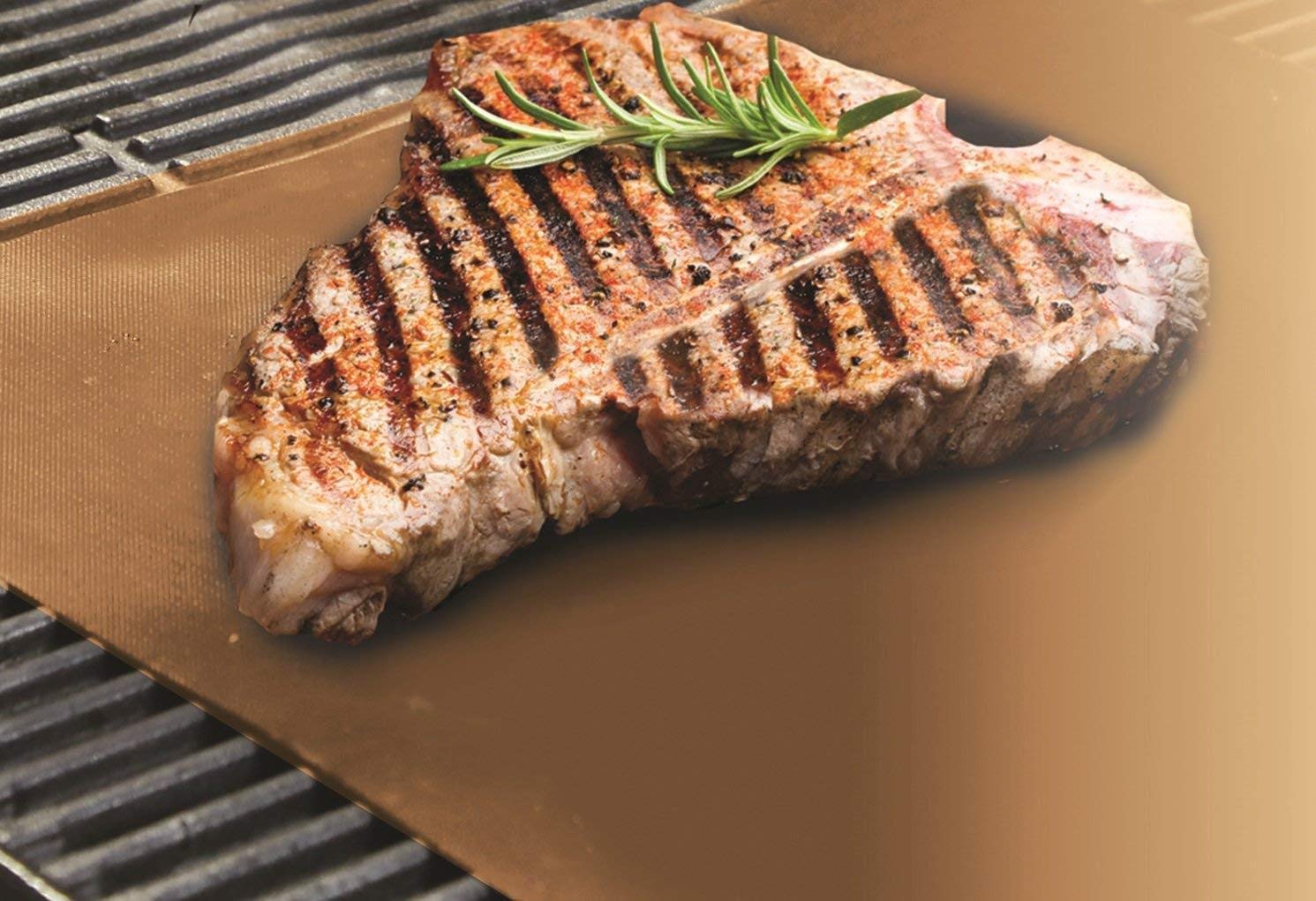 Yoshi Copper mat in use on grill with vegetables, preventing sticking and flare-ups